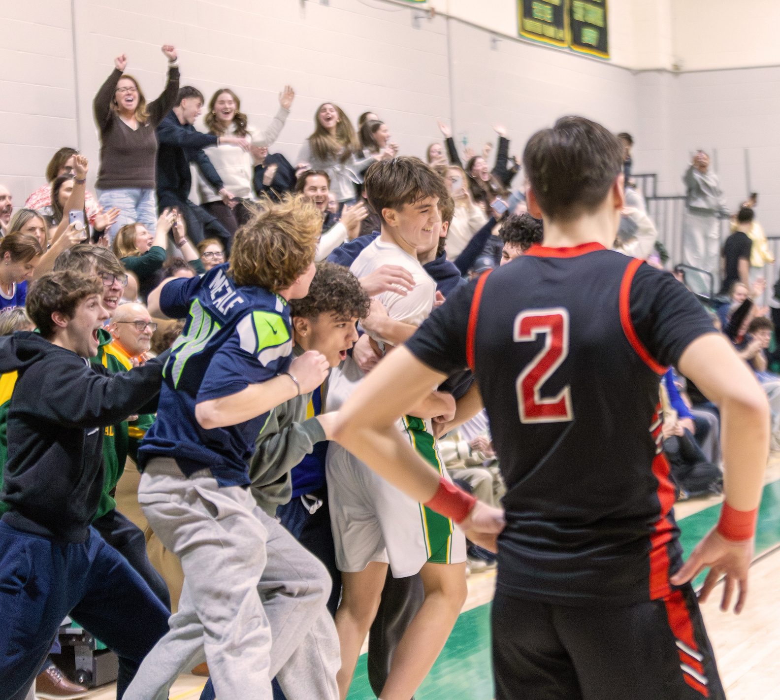 Students rushing the court to celebrate a basketball win